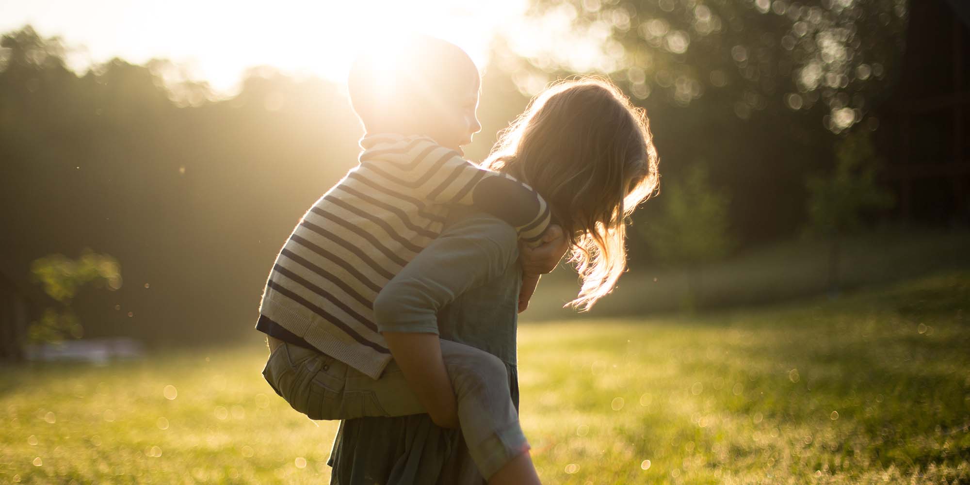 Child carrying another child on her back