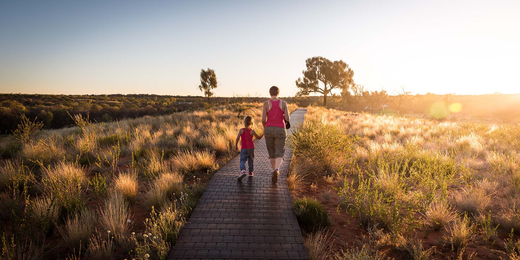 Mother and son on a walk, holding hands